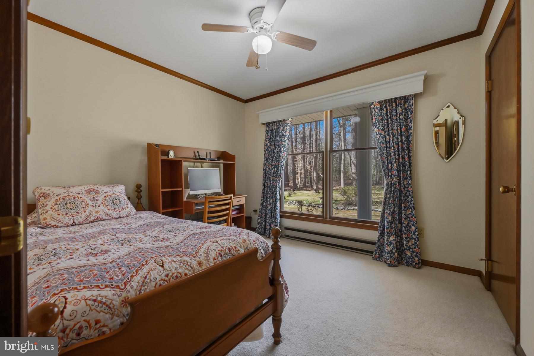 9829 Bantry Road Easton, MD 21601 - Photo 37 of 65 a bedroom with a bed and a chandelier