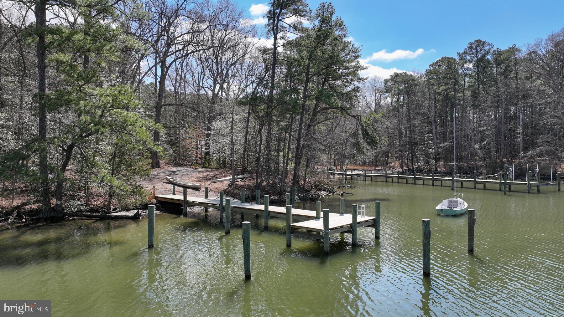 9829 Bantry Road Easton, MD 21601 - Photo 57 of 65 a view of a lake with boats and trees in the background