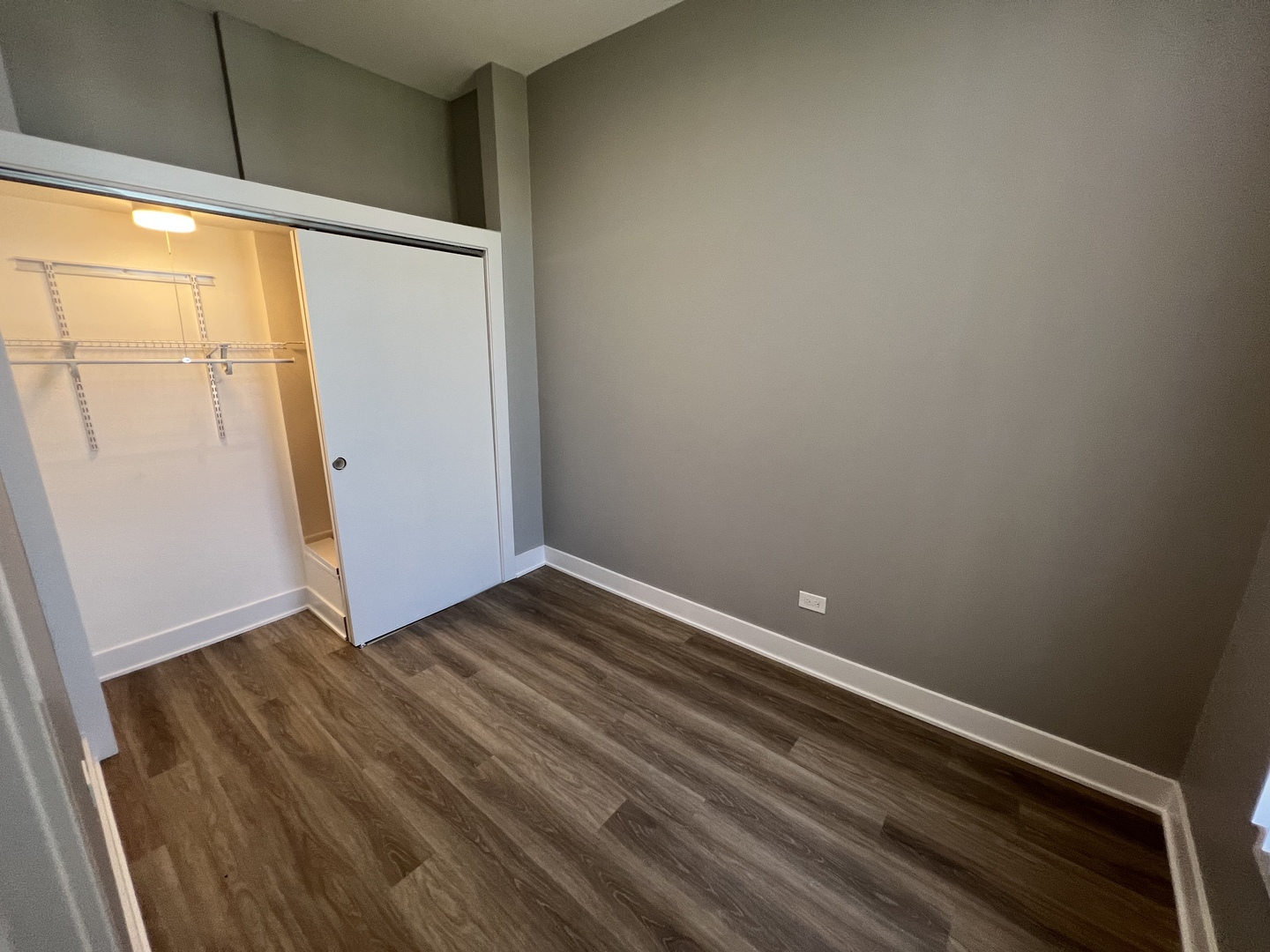 1227 West Ohio Street, Unit 3 Chicago, IL 60642 - Photo 15 of 18 a view of an empty room with wooden floor and a window