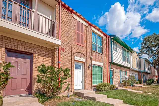 a view of a building with a yard