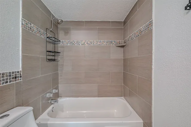 a bath tub sitting next to a white sink