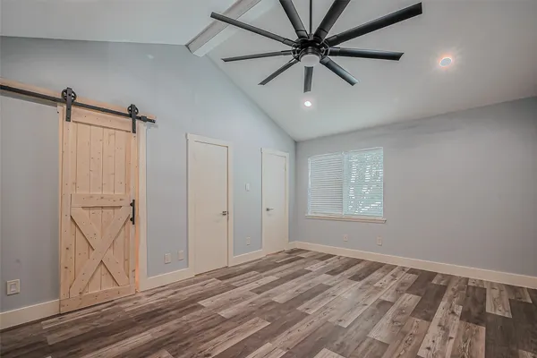 a view of a livingroom with a ceiling fan and wooden floor