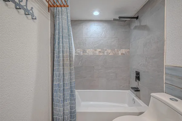 a bathroom with a bathtub and a shower