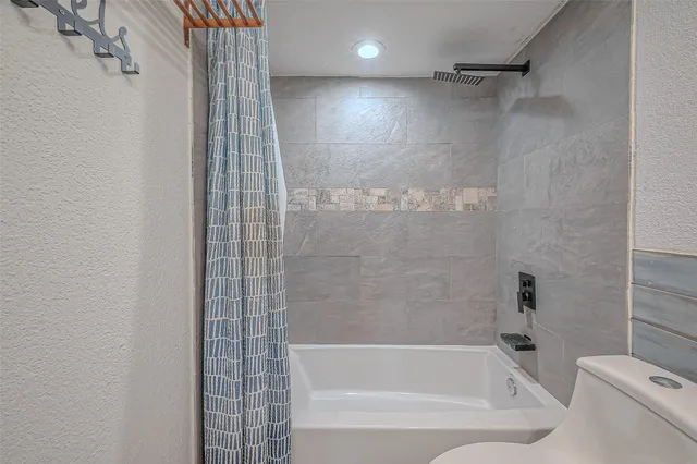 a bathroom with a bathtub and a shower