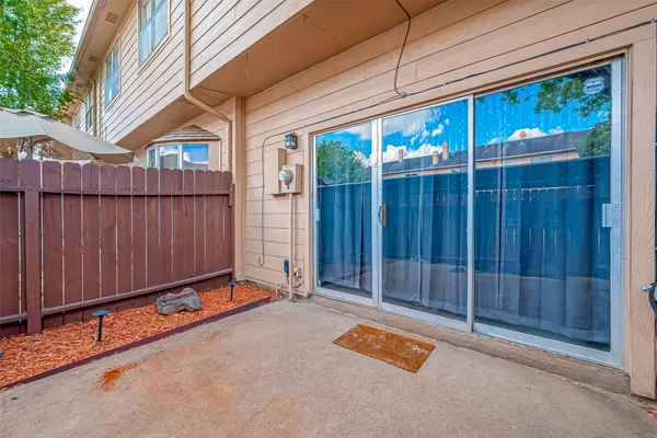 a view of backyard with tub and wooden fence