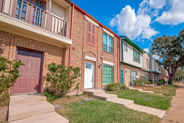 a view of a building with a yard