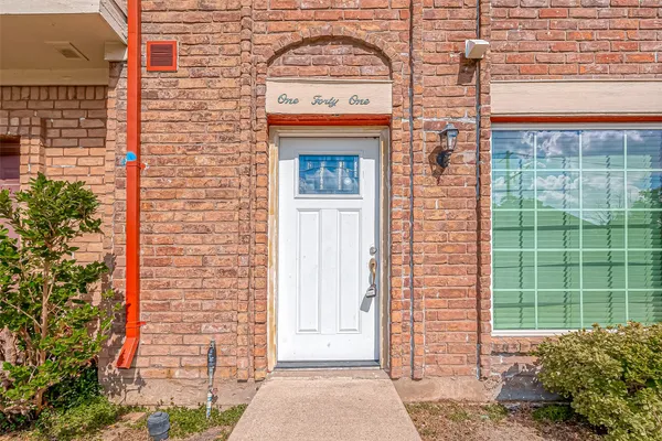 a front view of a house with large windows