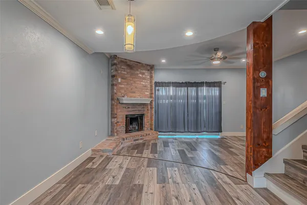a view of livingroom with an empty space and a fireplace