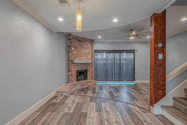 a view of livingroom with an empty space and a fireplace