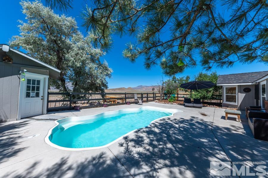 5940 Grass Valley Road Reno, NV 89510 - Photo 19 of 39 a view of a swimming pool with lounge chair