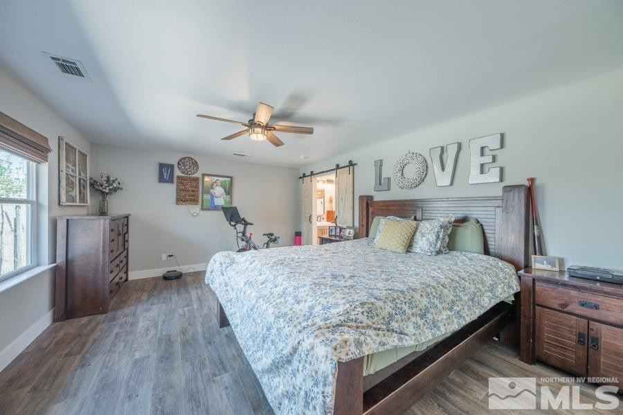 5940 Grass Valley Road Reno, NV 89510 - Photo 10 of 39 a bedroom with a large bed and a chandelier