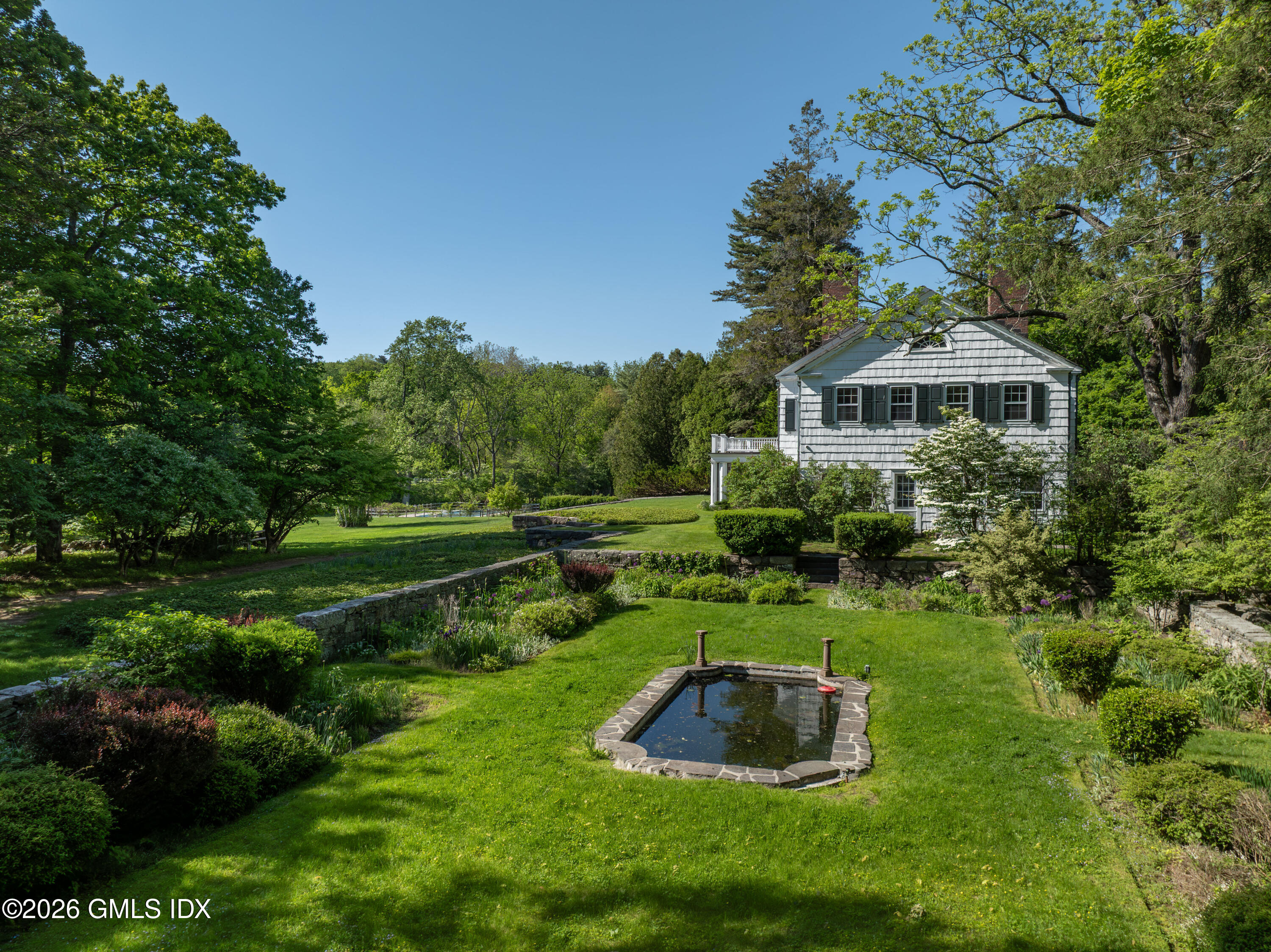 122 Round Hill Road Greenwich, CT 06831 - Photo 26 of 37 a view of a garden with large trees