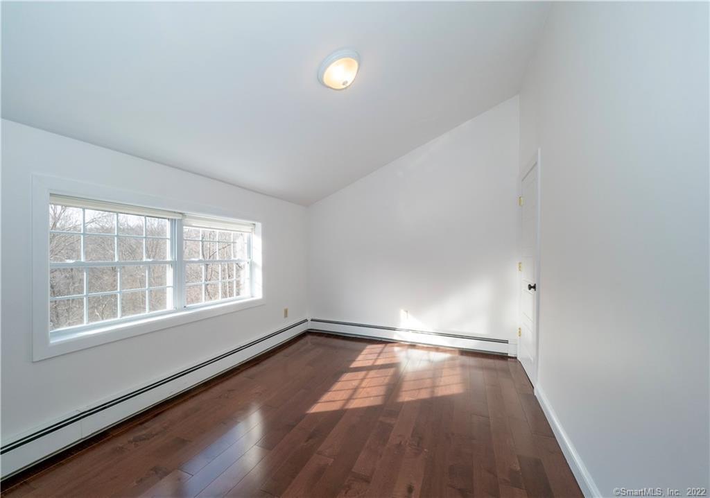 107 Black Rock Turnpike, Unit C Redding, CT 06896 - Photo 11 of 15 wooden floor in an empty room with a window