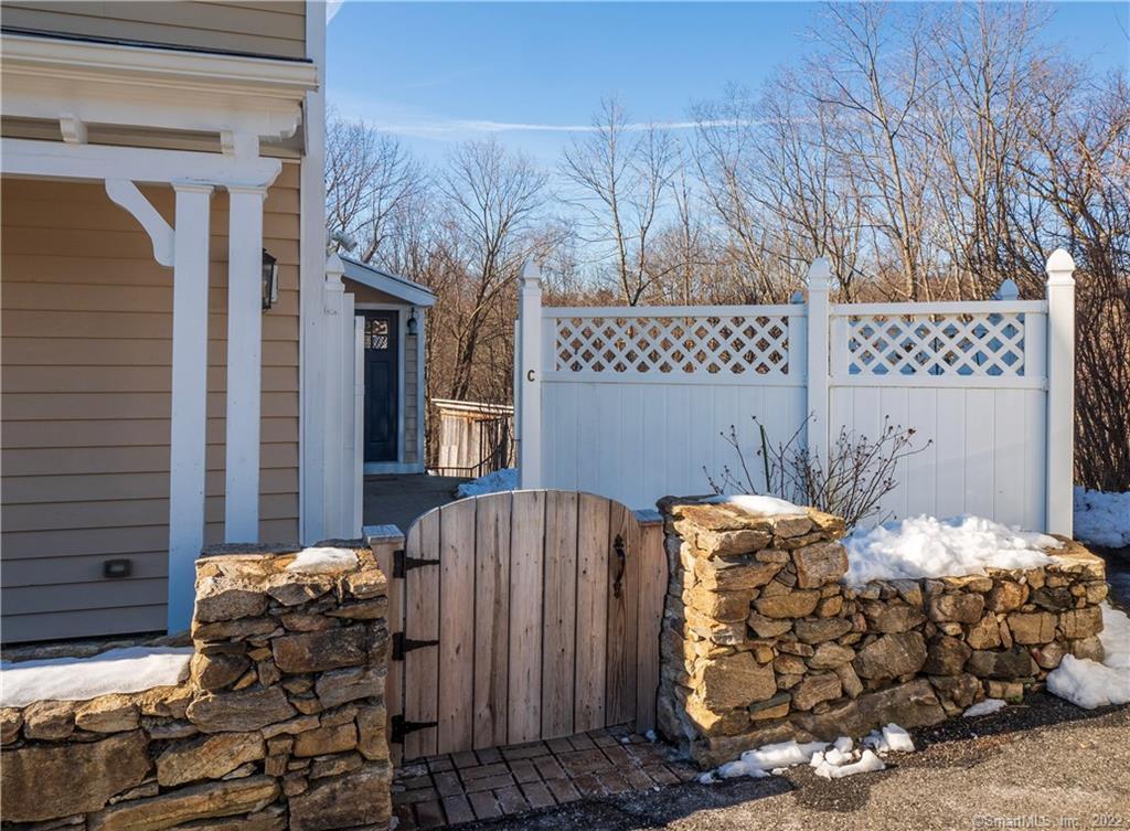 107 Black Rock Turnpike, Unit C Redding, CT 06896 - Photo 14 of 15 a bed sitting in a bedroom next to a window and a mirror