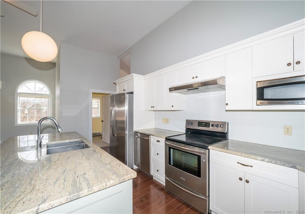 107 Black Rock Turnpike, Unit C Redding, CT 06896 - Photo 7 of 15 a kitchen with granite countertop a sink stainless steel appliances and cabinets