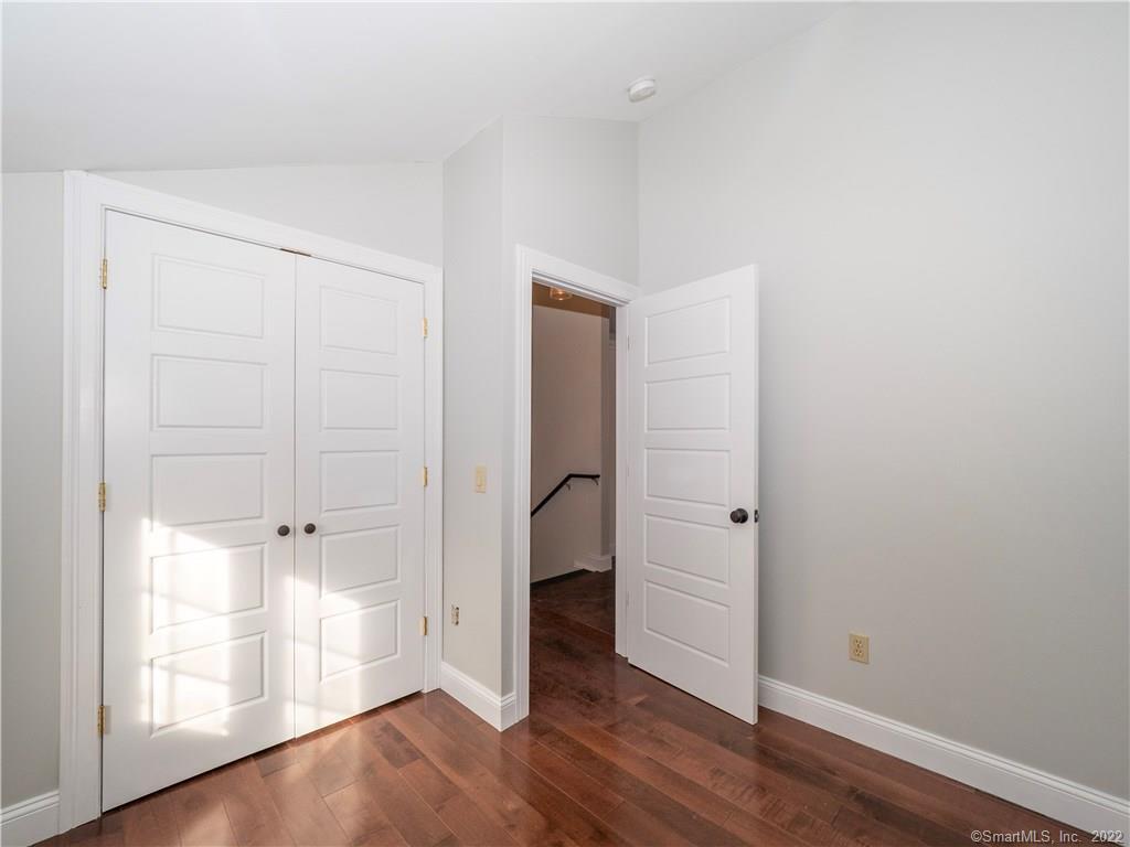 107 Black Rock Turnpike, Unit C Redding, CT 06896 - Photo 10 of 15 an empty room with wooden floor and closet