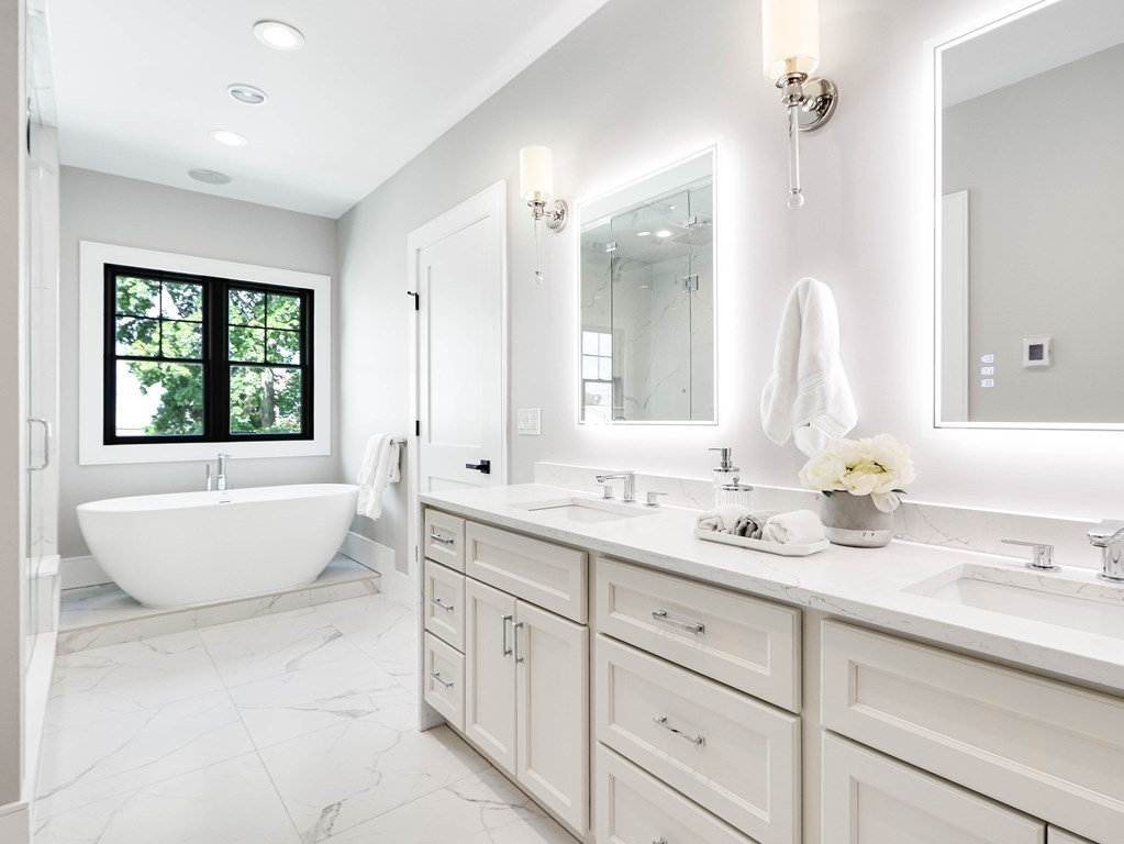 8 Manson Road Needham, MA 02494 - Photo 27 of 36 a spacious bathroom with a double vanity sink large mirror bathtub and window