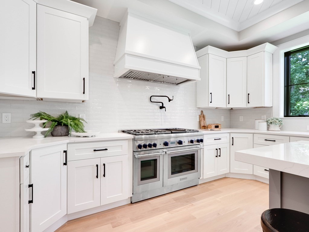 8 Manson Road Needham, MA 02494 - Photo 4 of 36 a kitchen with white cabinets and white appliances