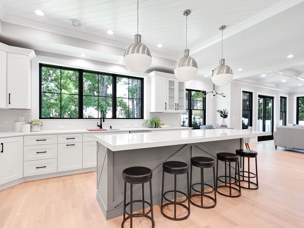 8 Manson Road Needham, MA 02494 - Photo 5 of 36 a kitchen with a center island white cabinets and stainless steel appliances