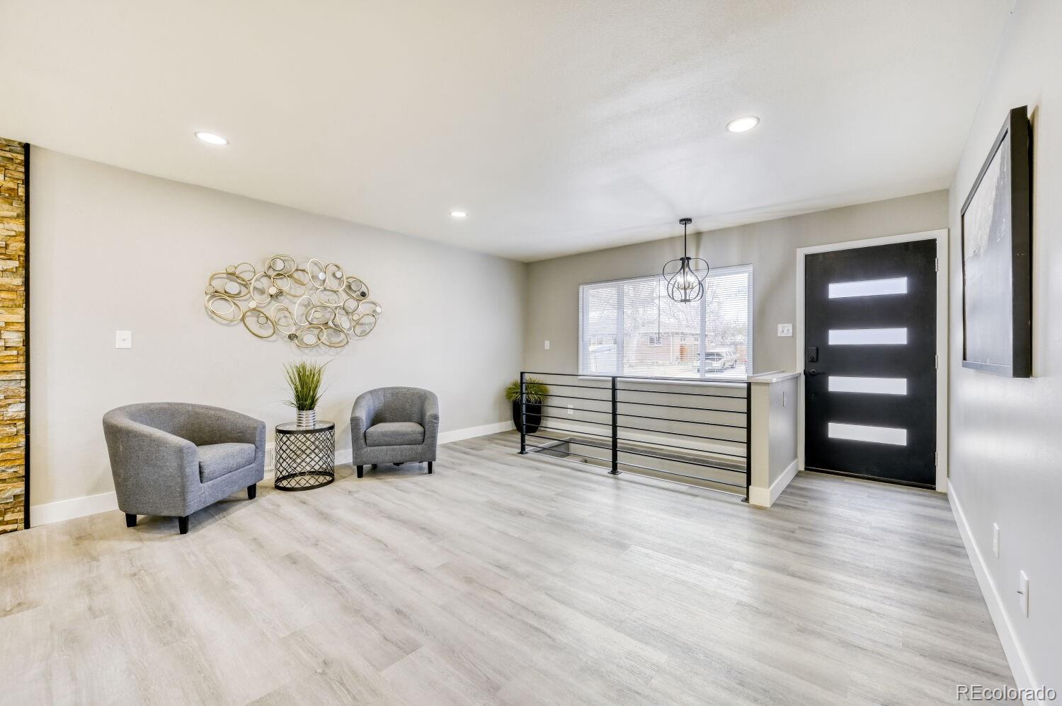 6623 Kipling Street Arvada, CO 80004 - Photo 12 of 39 a room with furniture and wooden floor