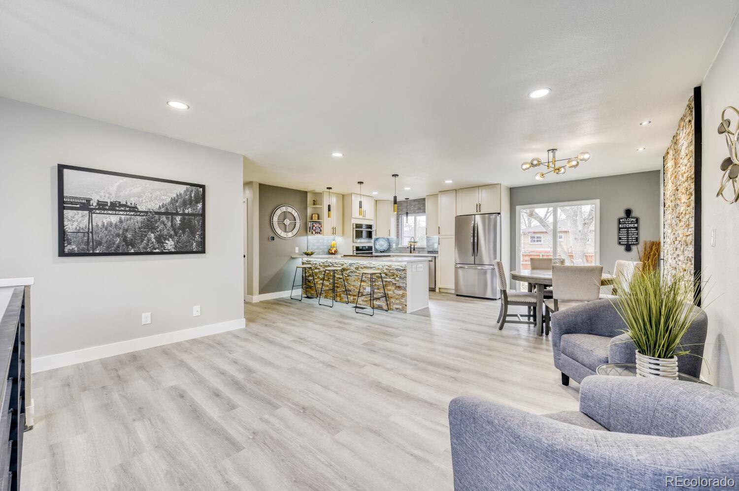 6623 Kipling Street Arvada, CO 80004 - Photo 14 of 39 a living room with furniture and wooden floor