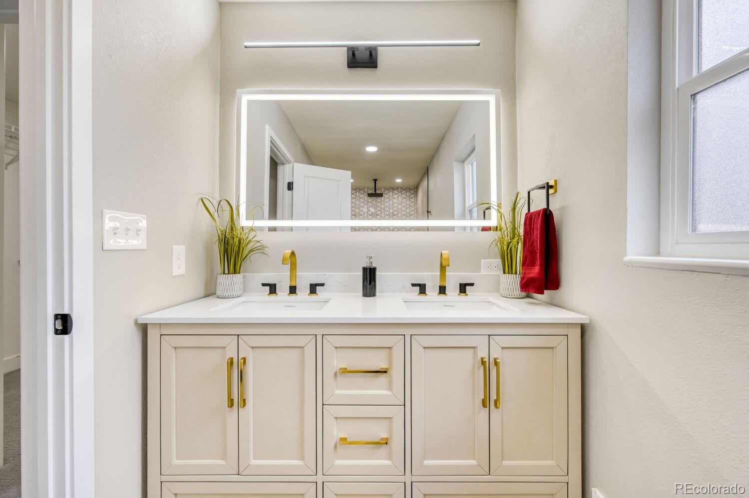 6623 Kipling Street Arvada, CO 80004 - Photo 20 of 39 a bathroom with a sink and a mirror