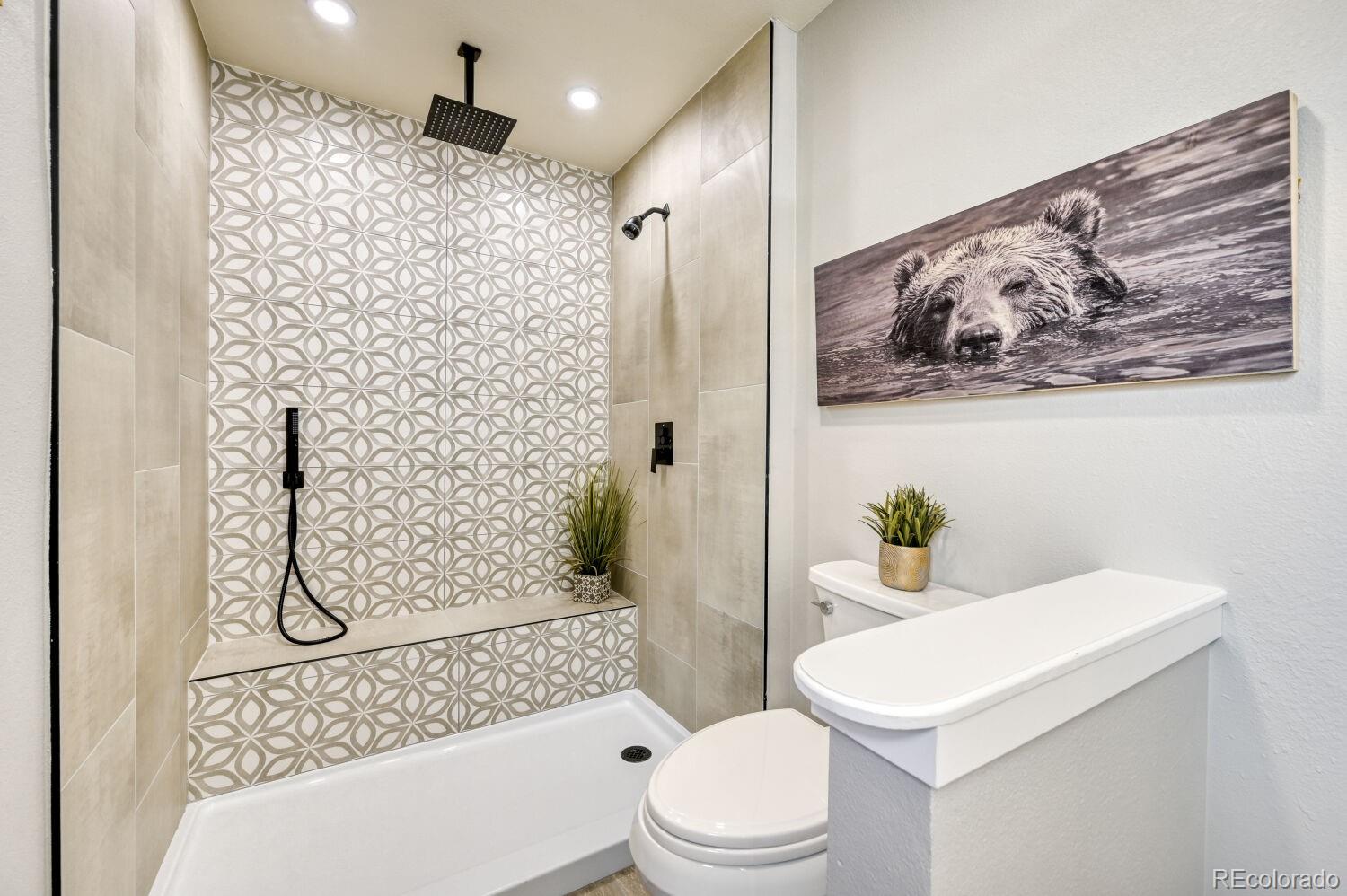 6623 Kipling Street Arvada, CO 80004 - Photo 21 of 39 a white toilet sitting next to a bathroom sink