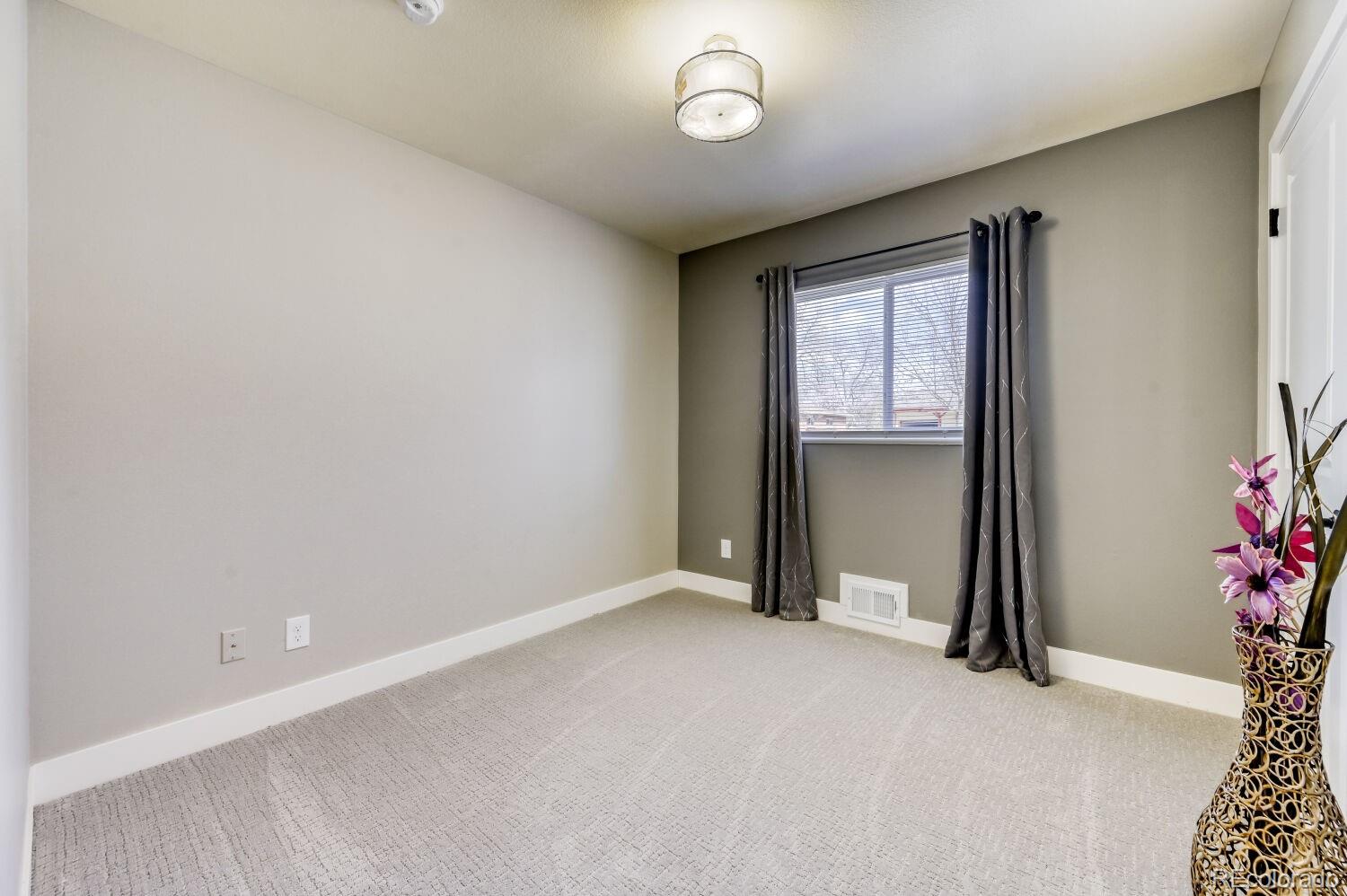 6623 Kipling Street Arvada, CO 80004 - Photo 22 of 39 an empty room with a window