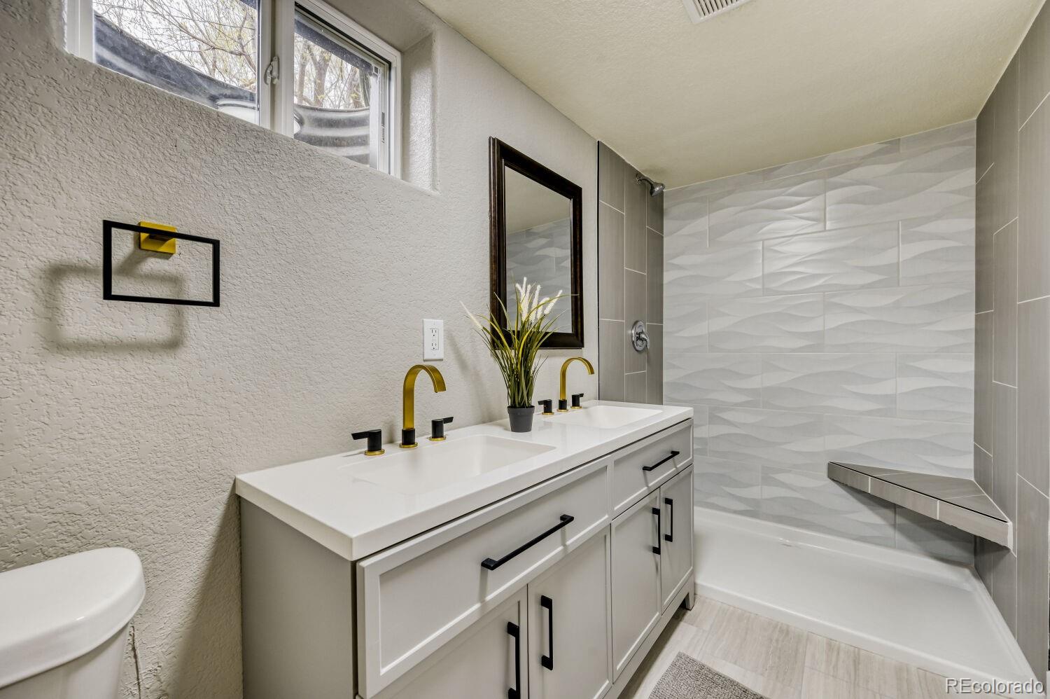6623 Kipling Street Arvada, CO 80004 - Photo 23 of 39 a bathroom with a sink and a toilet
