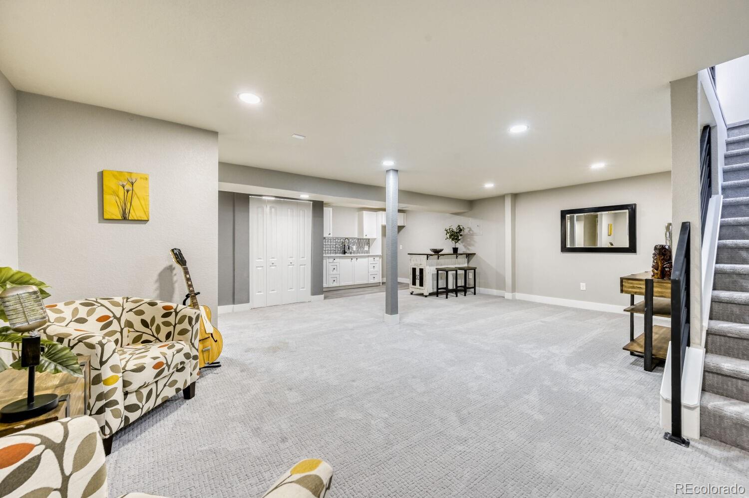 6623 Kipling Street Arvada, CO 80004 - Photo 24 of 39 a view of a livingroom with furniture and a flat screen tv