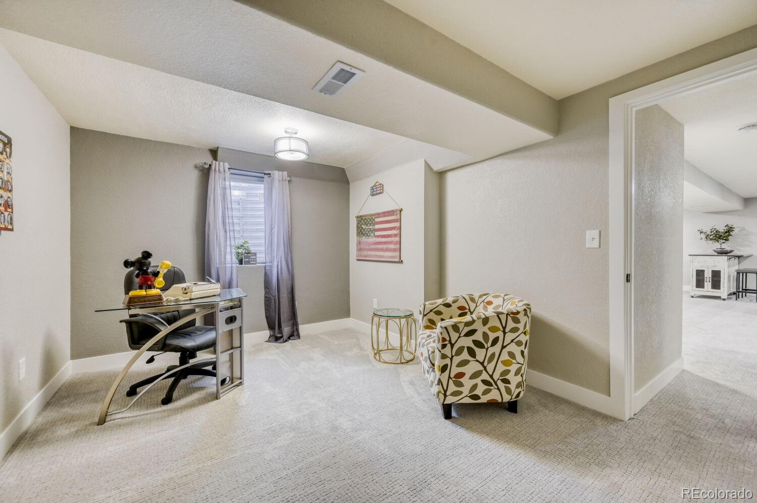 6623 Kipling Street Arvada, CO 80004 - Photo 26 of 39 a livingroom with workspace and a couch