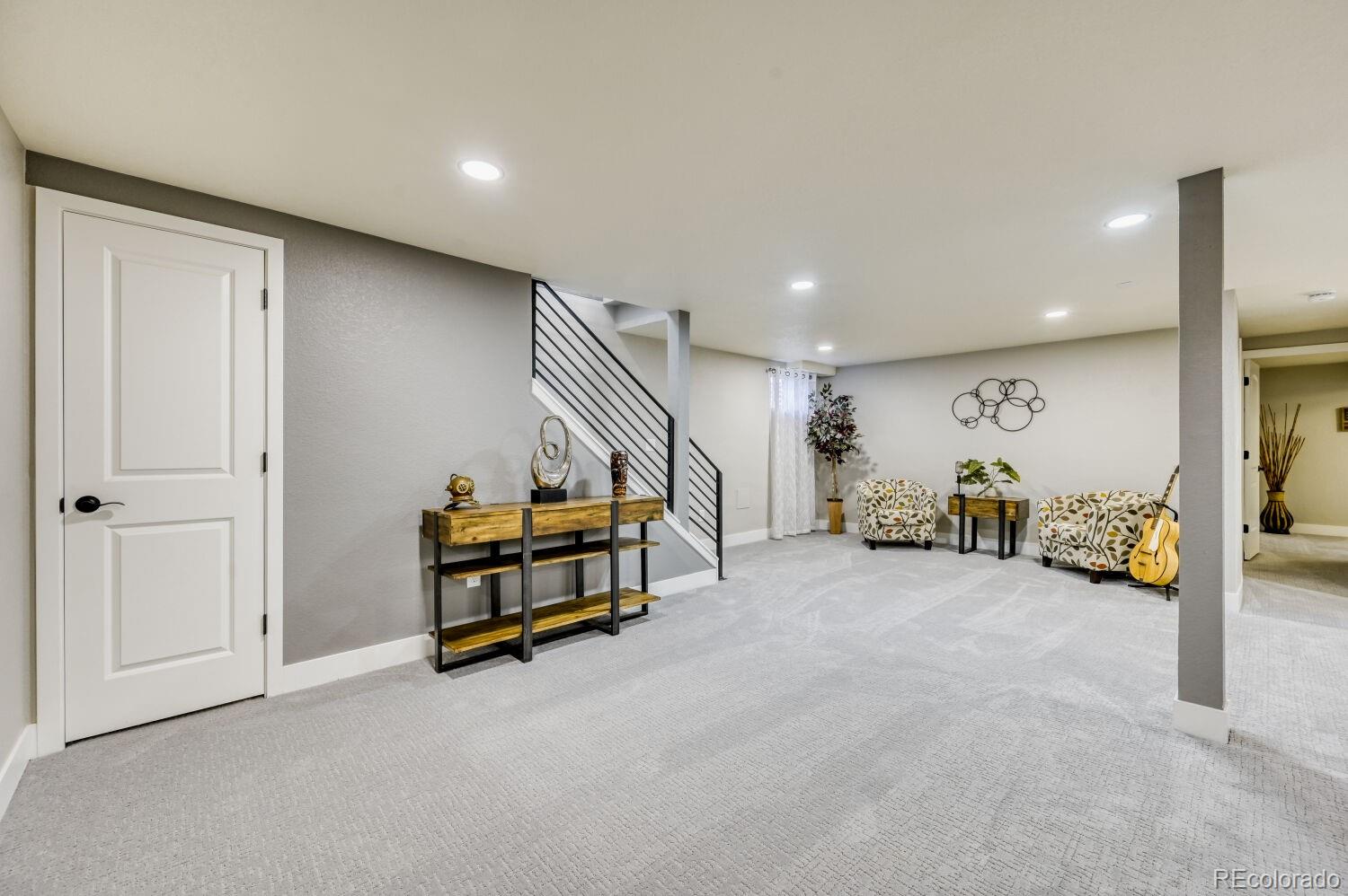 6623 Kipling Street Arvada, CO 80004 - Photo 29 of 39 an empty room with toys and a chandelier