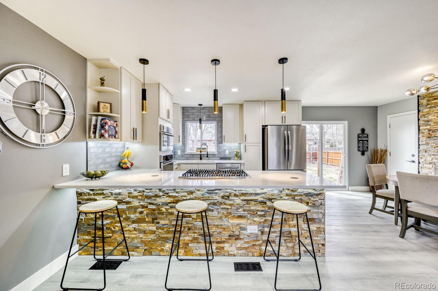 6623 Kipling Street Arvada, CO 80004 - Photo 3 of 39 a large kitchen with a table and chairs