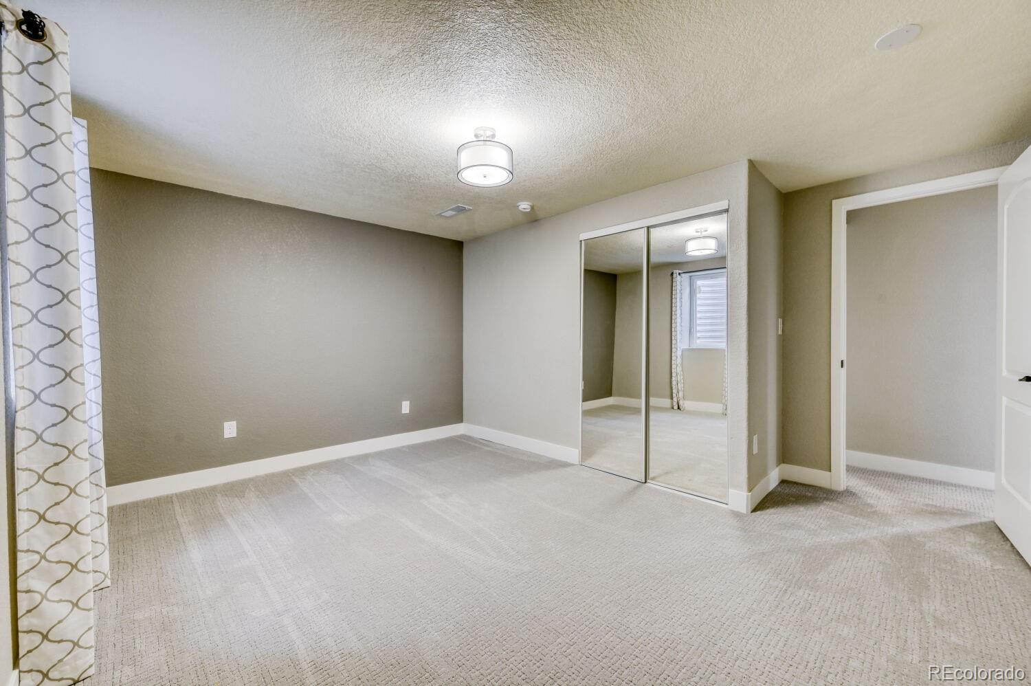 6623 Kipling Street Arvada, CO 80004 - Photo 31 of 39 en empty room with windows