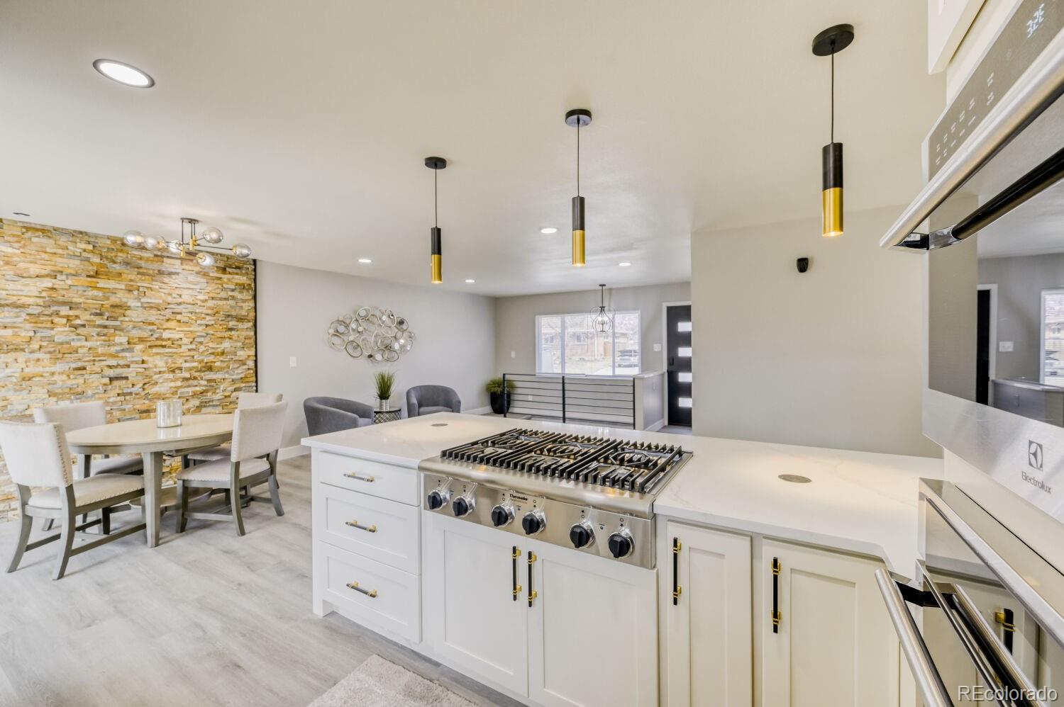 6623 Kipling Street Arvada, CO 80004 - Photo 5 of 39 a kitchen that has a stove and a table