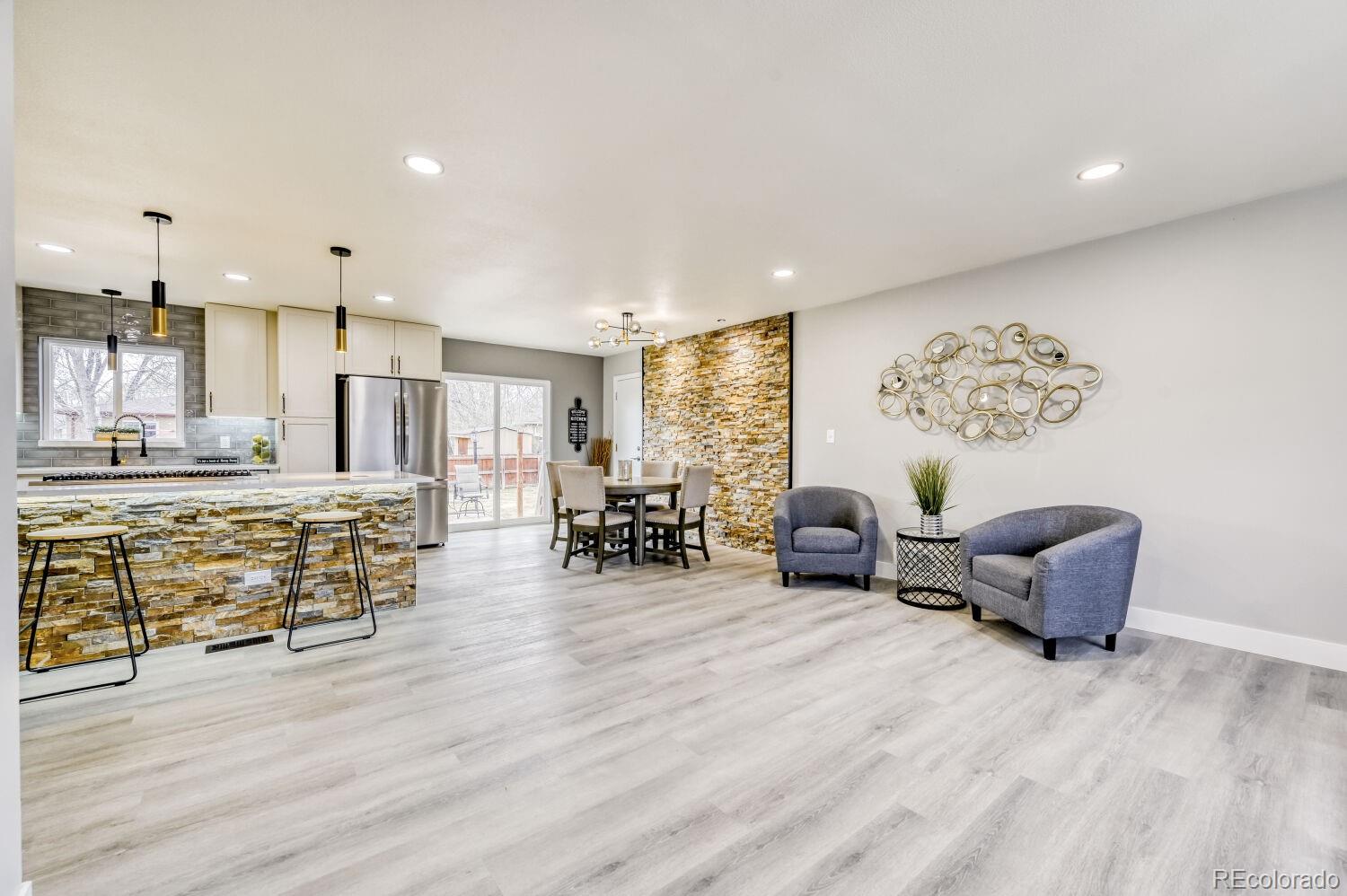 6623 Kipling Street Arvada, CO 80004 - Photo 9 of 39 a living room with furniture and kitchen view