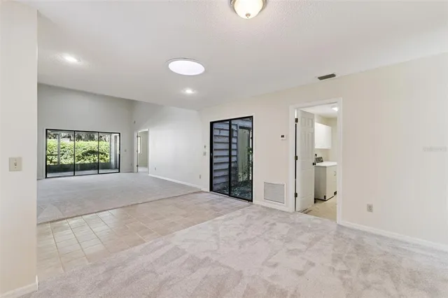 a view of an empty room with glass door