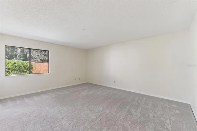 a view of an empty room with glass door