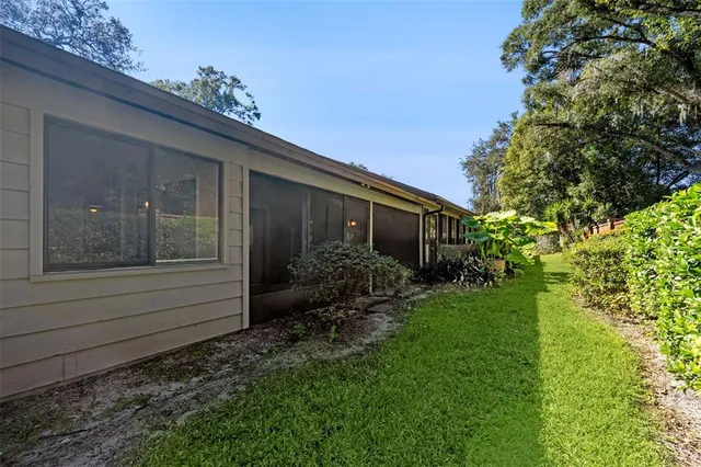an aerial view of residential houses with outdoor space and trees