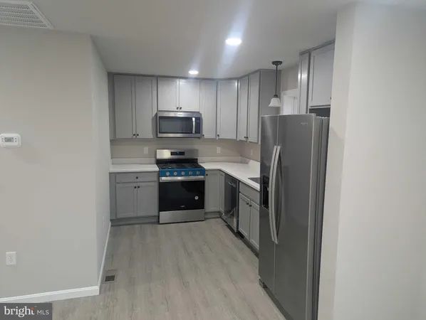 a kitchen with stainless steel appliances a refrigerator stove and sink