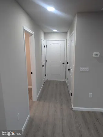 a view of a hallway with wooden floor