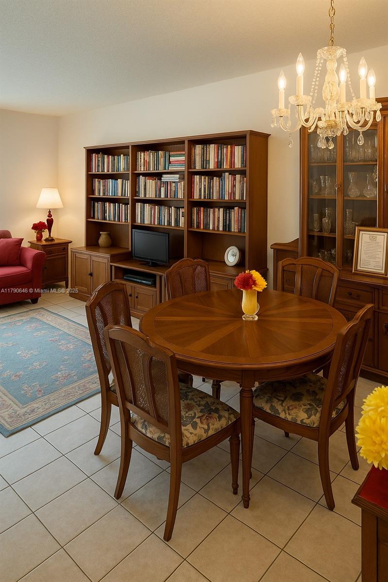 4881 Northwest 22nd Street, Unit B7 Lauderhill, FL 33313 - Photo 4 of 13 a view of a dining room with furniture and chandelier
