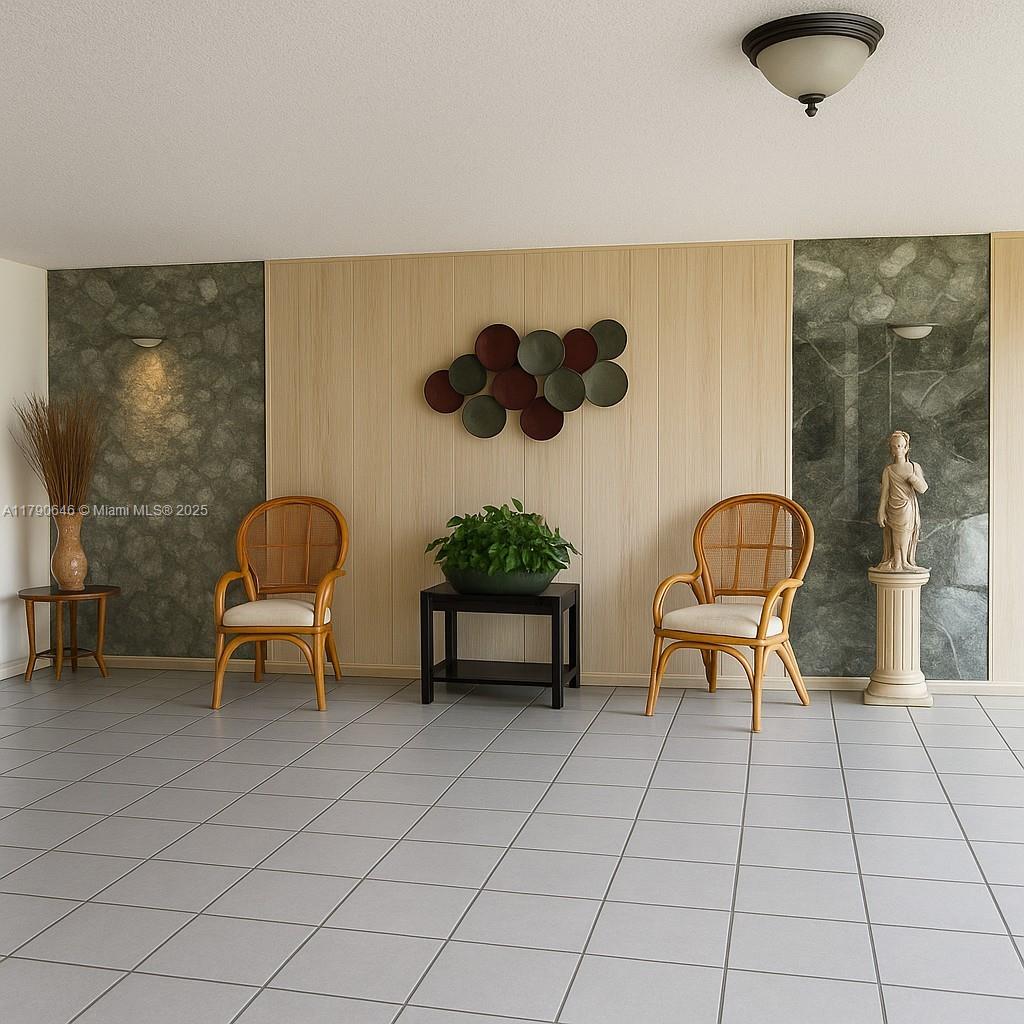 4881 Northwest 22nd Street, Unit B7 Lauderhill, FL 33313 - Photo 8 of 13 a living room with furniture and a chair