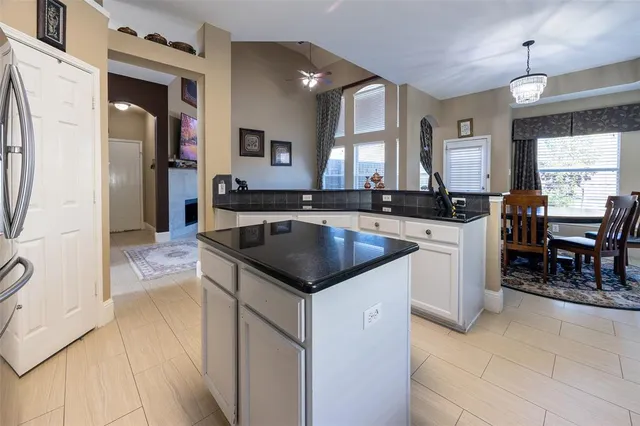 a kitchen with stainless steel appliances granite countertop a sink and a refrigerator