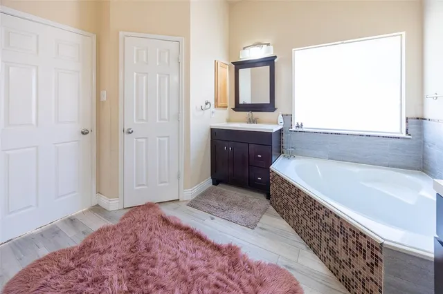 a spacious bedroom with a bed and a window