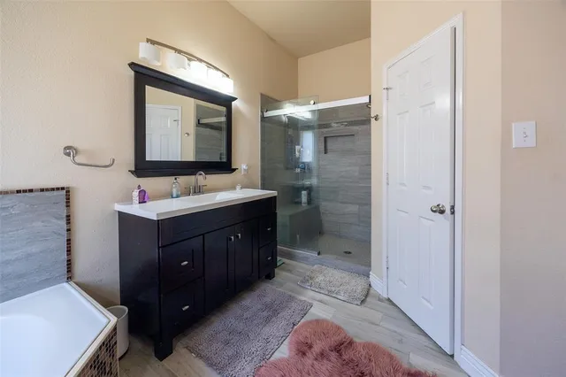 a bathroom with a sink vanity and mirror
