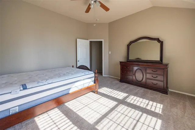 a bedroom with a bed and a dresser