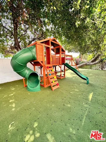 a backyard of a house with table and chairs