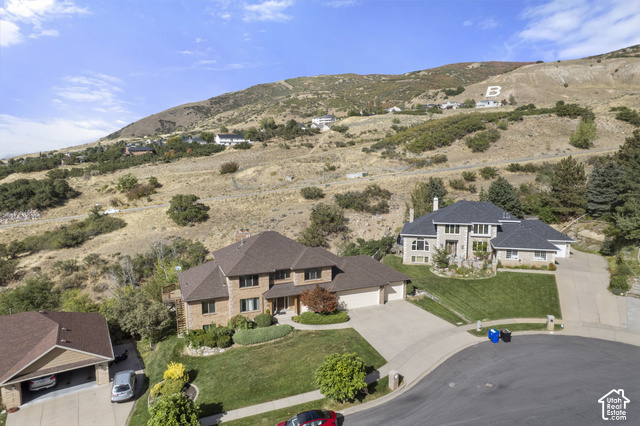 1373 Pheasant Ridge Circle Bountiful, UT 84010 - Photo 47 of 50 Stunning two-story residence with brick and stone exterior, situated on expansive grounds featuring manicured lawns, mature landscaping, and rolling hillside backdrop