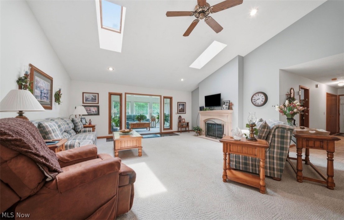 3556 Lake Road Conneaut, OH 44030 - Photo 10 of 39 Spacious living area featuring vaulted ceilings with skylights, a ceiling fan, and recessed lighting